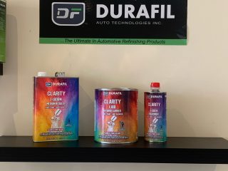 Durafil Clarity Product Line I-180RM Medium Reducer, I-180 Hybrid Ccarrier, and iI-180H Hardener (pictured on shelf with Durafil Auto Technologies, Inc banner)